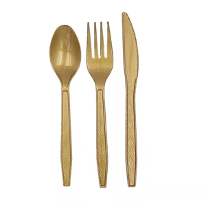 Detailed view of shiny gold plastic cutlery set including knife, fork, and spoon for party