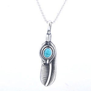Punk style silver feather pendant necklace with turquoise stone on white background