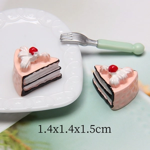 Macro shot of 1.4cm miniature resin sandwich cake with pink cream and cherry detail