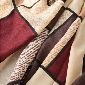 Elegant geometric patchwork silk scarf in burgundy and beige with fine woven texture