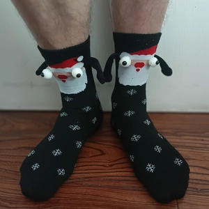 Detail of Christmas magnets socks with 3D Santa Claus and cute snowflake patterns