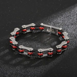 Macro detail of bike chain bracelet with silver-black links and inlaid red crystals