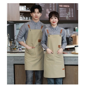Coffee shop baristas wearing professional khaki canvas aprons with leather straps and pockets