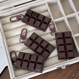 Set of four realistic dark chocolate block keychains with matching brown metal clasps