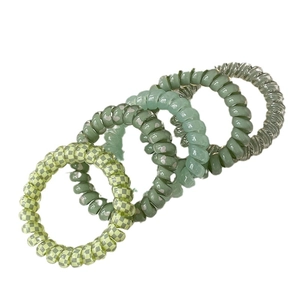 Set of 4 green spiral hair ties including checkered and translucent jelly styles