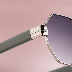 Macro detail of high-quality metal hinge and textured temple on square sunglasses