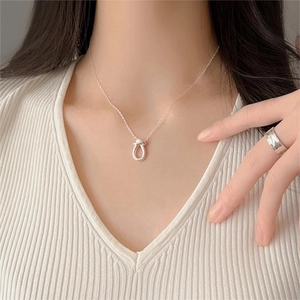 Minimalist 925 sterling silver knot necklace with horseshoe pendant on a female model