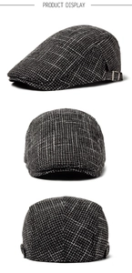 Detail of vintage black and white plaid linen beret with adjustable silver metal side buckle
