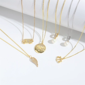 Artistic arrangement of gothic bus, pearl, and wing pendants on assorted chains