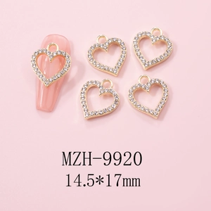 Macro detail of golden alloy heart pendant with white rhinestones for Y2K nail art design