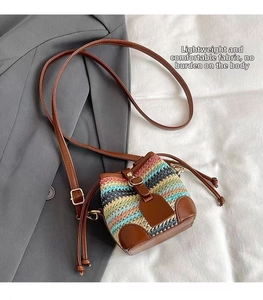 Detailed macro view of colorful rainbow woven bucket bag with brown faux leather drawstring