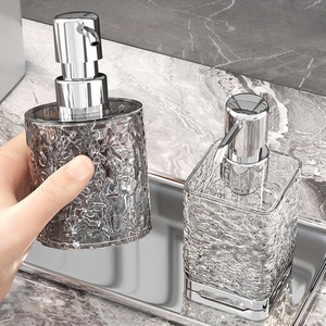 Elegant grey ice-cracked glass soap dispenser with silver pump and matching luxury tray