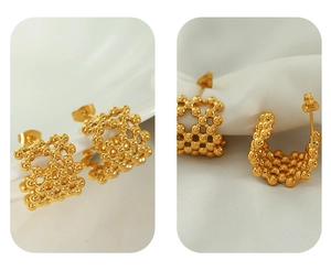 Macro shot of 18K gold plated mesh beads C-shape earrings with hollow woven texture