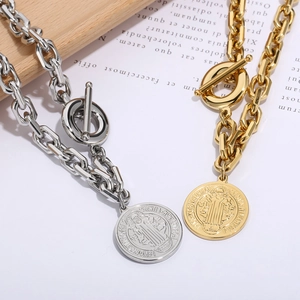 Gold and silver chunky chain necklaces featuring religious Saint Benedict coin pendants