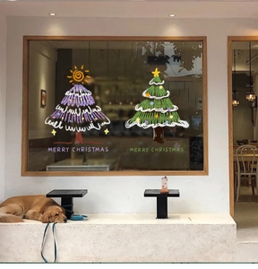 Detail of hand-drawn Christmas tree stickers on a glass window with festive home decor