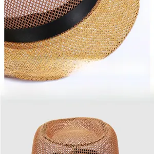 Detail of breathable mesh weave and black ribbon on a tan straw panama sun hat