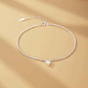 Macro shot of silver sterling heart-cut zircon bracelet with glittering link chain