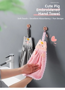 Detail of pink and grey coral fleece hand towels with cute pig embroidery and hanging loops