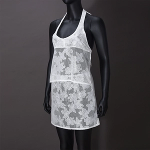 Detail of white floral lace hollow out pattern on halter neck sleeveless summer dress