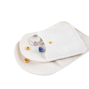 Elegant white velvet jewelry pouches with gold snap buttons for rings and bracelets