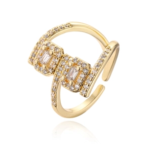 Adjustable gold plated geometric ring with cubic zirconia stones on white background