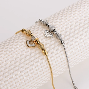 Snake chain bracelets in gold and silver with elegant Ruyi pattern lock pendants
