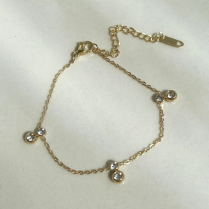 Elegant 18k gold plated bracelet featuring three double zircon crystals on a fine chain