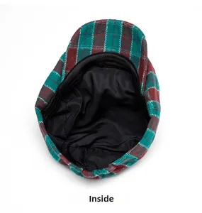 Detailed macro view of the black fabric lining and red plaid pattern stitching on the cap