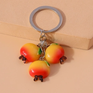 Detailed view of realistic resin persimmon fruit pendants on a durable metal keychain
