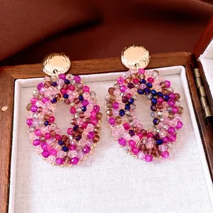 Handcrafted oval beaded hoop earrings with faceted crystal beads and golden hammered studs