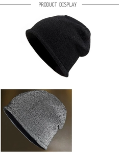 Detail view of reflective knit beanie texture in black and grey for outdoor warmth