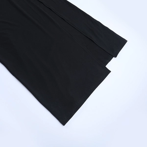 Detailed close-up of the black mesh dress hemline featuring professional split stitching