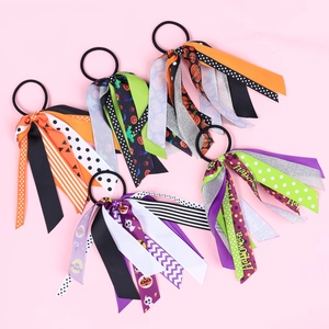 Set of five Halloween themed ribbon hair ties featuring festive pumpkin patterns