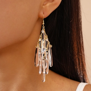 Elegant gold drop earrings with clear crystal tassels worn on model for a stylish look