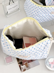 Inside view of a large quilted lemon dot wash bag showing ample space for cosmetics