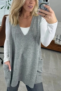 Close-up of gray V-neck knitted sweater vest with side pockets and smooth texture