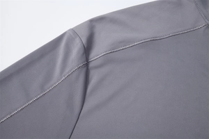 Detail of four-needle six-thread reinforced sewing on gray sun protection shirt shoulder