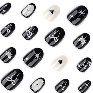 Gothic black and white press-on nails with silver bows, hearts and pearls design