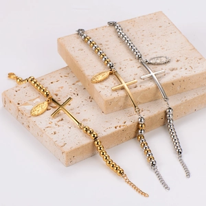 Stainless steel beaded bracelets with cross and Mary pendants on stone props