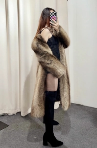 Close-up of the thick brown faux fox fur texture and long winter coat material