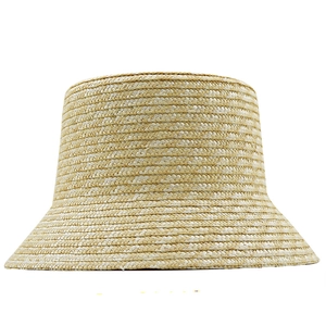 Detailed view of natural straw weave texture on a beige summer bucket sun hat