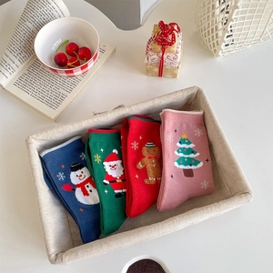Christmas cotton mid-tube socks featuring Santa and snowman patterns in a gift basket