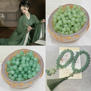 Macro detail of translucent light green glass beads with tassels for DIY jewelry making