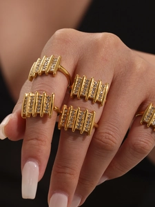 Macro detail of gold-plated textured ring with sparkling white zircon stones