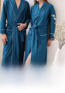 Close-up of navy blue waffle weave bathrobe showing texture, white trim and side pocket