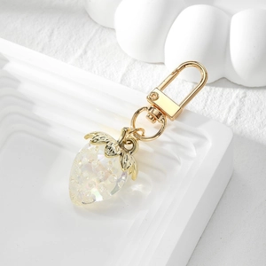 Macro view of a strawberry charm made of translucent resin with sparkling pearlescent effect
