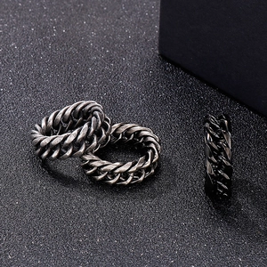 Macro shot of Cuban chain link rings in antique silver and black on matte background