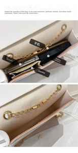 White leather crossbody bag interior showing storage space for phone and makeup items
