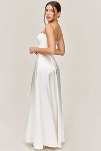 Detail view of white satin dress featuring elegant criss-cross lace-up back design