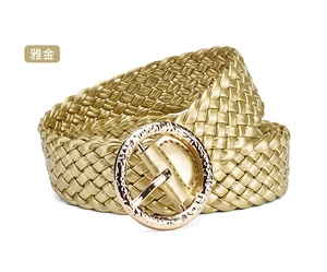 Detailed view of elegant gold woven PU leather belt with textured round metal buckle